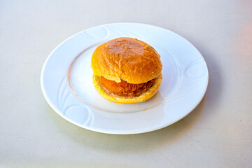 Big tasty burger with beef cutlet on a plate. Hamburger, cheeseburger with mushroom. Hamburger, Mexica, mushroom double cheddar  burger.  Crispy chicken burger. With french fries, patates kizartmasi.