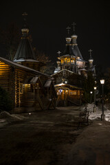 Wooden church in winter night Moscow by the light of street lamps