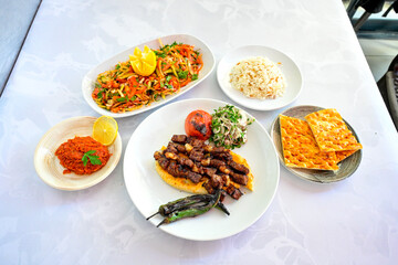 Famous Urfa meat liver, ciger wrapped by lavash with roasted chili pepper, onion and sauce in...