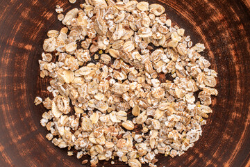 Oatmeal rolled with homemade kitchen utensils, close-up, top view.