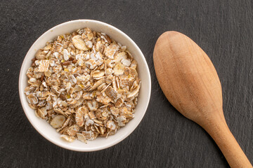 Oatmeal rolled with homemade kitchen utensils, close-up, top view.