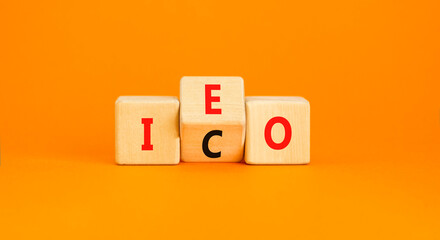 Initial coin or exchange offering symbol. Concept words abbreviation ICO or IEO on wooden block....