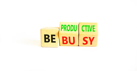 Be productive not busy symbol. Concept words Be productive Be busy on wooden block. Beautiful white...