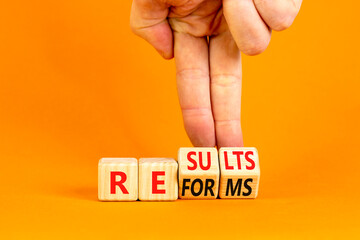 Reform and result symbol. Concept words Reforms Results on beautiful wooden block. Beautiful orange table orange background. Businessman hand. Business Reforms and results concept. Copy space.