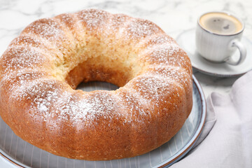 Freshly baked sponge cake and coffee on table, closeup