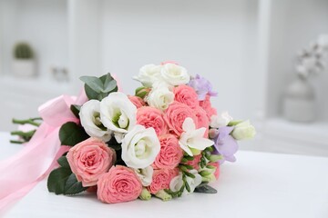 Beautiful wedding bouquet on white table indoors