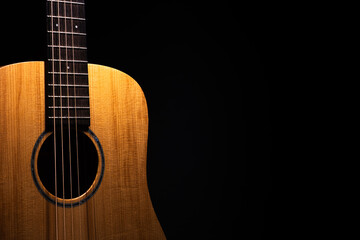 Acoustic guitar on black background