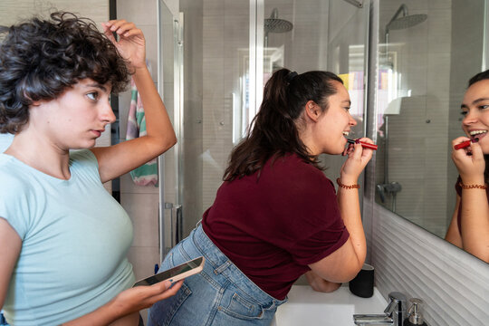 Morning routine of a lesbian couple in the bathroom - Powered by Adobe