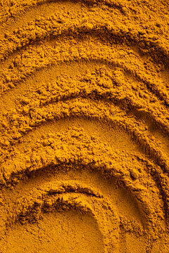 Close-Up of Curry Powder Texture with Curved Patterns