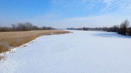 Winter Landscape Over A Frozen River With Clear Blue Sky And Snowy Fields