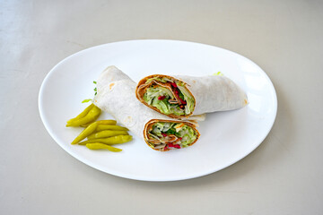 Cig kofte (raw meatball) with lettuce, tomato, pickle and lemon, hot Chee kofta. Turkish local raw food concept.Table scene of assorted take out or delivery foods. Doritoslu duble cig kofte durum.