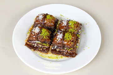 Turkish Dessert Sobiyet, havuc dilimi, midye baklava, mussels baklava and classic baklava with Pistachio . Cikolatali cevizli, fistikli soguk Baklava, top view.