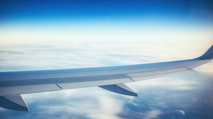 Obraz premium Majestic Plane Wing and Cloudscape from Airplane Window