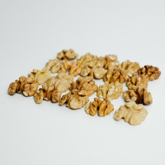 Walnut Kernels Arranged on White Background