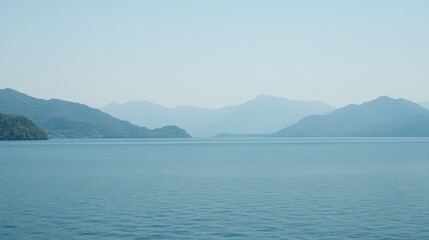 Calm Blue Waters with Mountain Range and Clear Sky in Tranquil Landscape