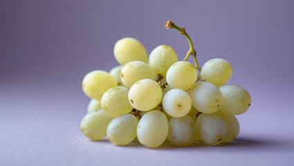 A Cluster of Pale Yellow Grapes on a Lavender Background