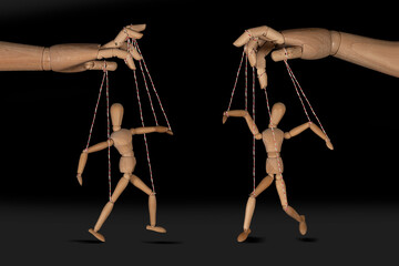 Wooden puppet doll, obeying master  hand pulling the strings of dancing marionette