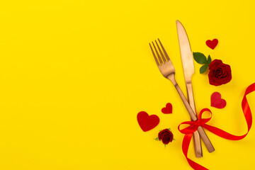 Table setting for Valentine's Day on color background, top view