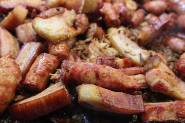 Grilled traditional sausage and different tipe of meat prepared on grill at a Christmas market where various traditional dishes are served.