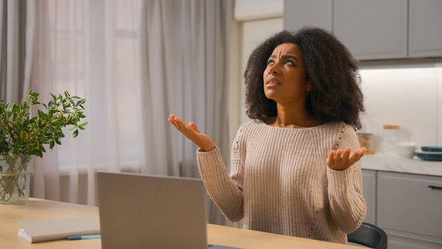 Annoyed angry woman African American businesswoman freelancer online working laptop at home kitchen stressed displeased mad female girl scream crazy with noise sound close ears disturb noisy at house