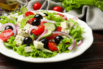 Delicious salad with feta cheese on wooden table, closeup