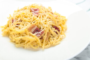 Delicious pasta Carbonara with bacon on plate, closeup