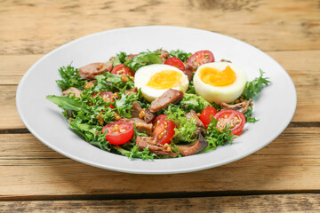 Delicious fresh tuna salad on wooden table, closeup