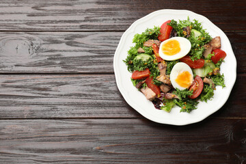 Delicious fresh tuna salad on wooden table, top view. Space for text