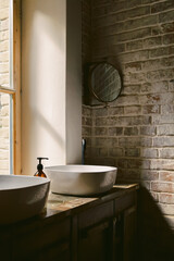 Fragment of a bathroom interior, with a sink, mirror and window