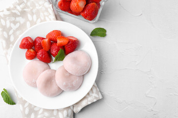 Delicious mochi and strawberries on white table, top view. Space for text