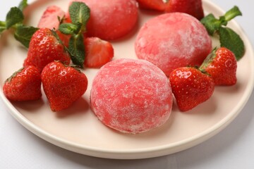 Delicious mochi, strawberries and mint on light table, closeup