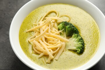 Delicious broccoli cream soup in bowl on gray table, closeup