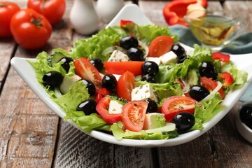 Delicious fresh Greek salad on wooden table, closeup