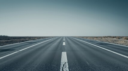 Endless Asphalt Highway Stretching Towards a Clear Horizon