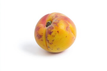 Fototapeta premium A single peach sitting on a clean white surface