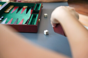 Rolling dice on a backgammon board for strategic gameplay