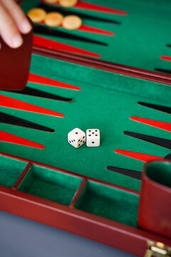 Playing backgammon with dice and board set close-up