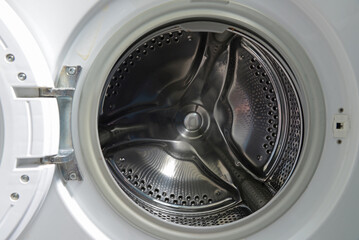 Empty metal drum washing machine closeup