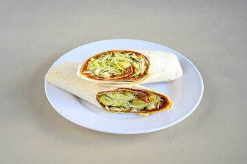 Cig kofte (raw meatball) with lettuce, tomato, pickle and lemon, hot Chee kofta. Turkish local raw food concept.Table scene of assorted take out or delivery foods. Doritoslu duble cig kofte durum.