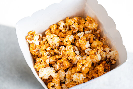 Top view of sweet caramel popcorn in a white container