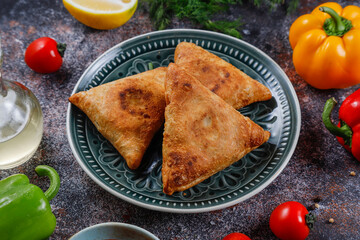 Fried samosas with vegetable filling, popular Indian snacks.