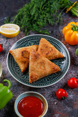 Fried samosas with vegetable filling, popular Indian snacks.