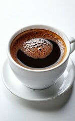 Fototapeta premium Black coffee in a white cup served on a saucer in a cozy cafe setting with natural light