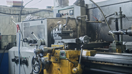 Industrial lathe machine engaging in precise metalworking within a factory environment, highlighting advanced manufacturing techniques and the intricacies of engineering processes