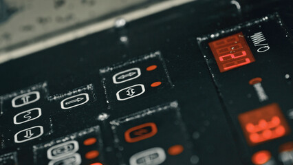 Close up view of a control panel displaying various settings, indicators, and a digital timer, suggesting the intricate operation of industrial equipment