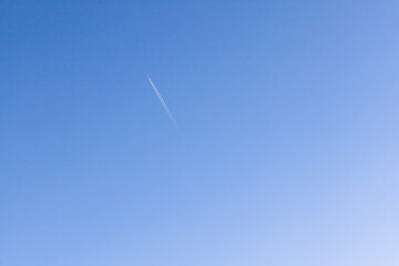 A single jet plane flying on the beautiful blue sky