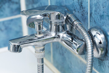 Dirty faucet with water stains and limescale. Bathroom cleaning concept with hard water residue...