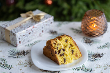 Italian pie with chocolate and dried fruits, traditional Christmas dessert against the background of a decorated Christmas tree
