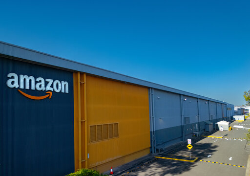 View of the Amazon Fulfilment Centre BWU1 warehouse showing the Amazon sign and corporate Amazon logo in Moorebank, Sydney NSW Australia 