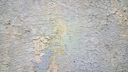 Aged and weathered white wall with multiple cracks and fractures, distressed surface texture background for design and architecture
